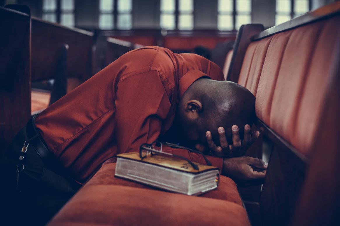 PRAYING AFRICAN AMERICAN MAN