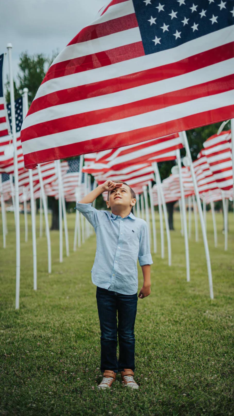 Boy saluting US flag
