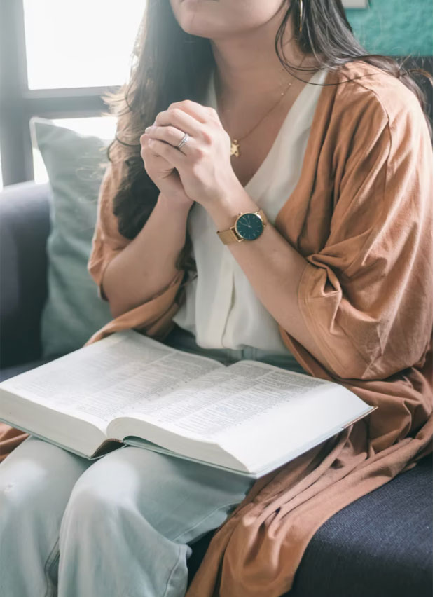 Lady praying over Bible