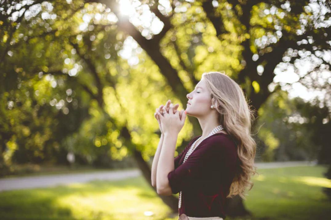 Woman looking up and praying